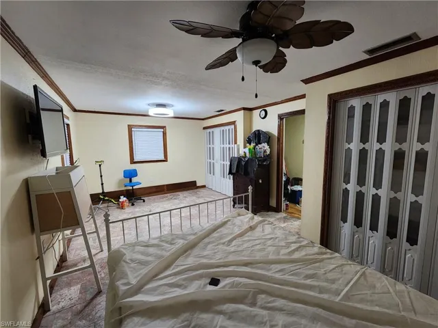 Bedroom featuring crown molding and ceiling fan
