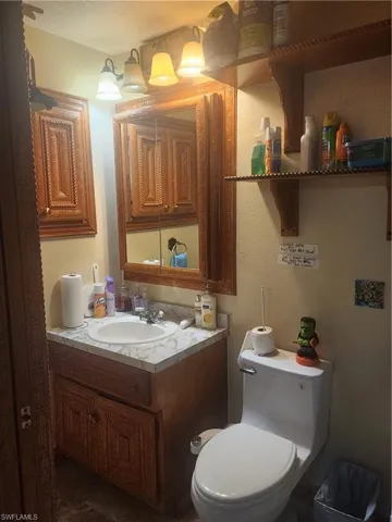 Primary Bathroom featuring vanity and a textured wall
