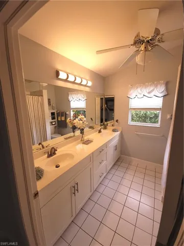 Large Guest Bathroom featuring vanity, toilet, ceiling fan, and tiled floors