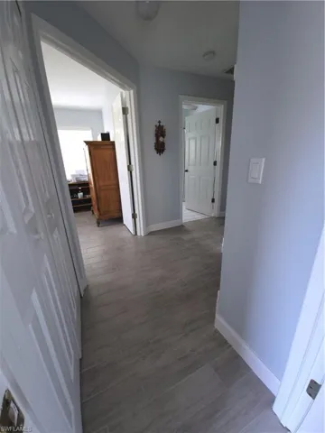 Hall with light wood-type tile flooring