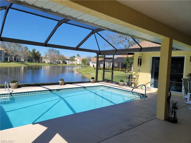 View of recently refinished pool with large under truss area, newly installed PANORAMIC view enclosure, ceiling fan, and a water view