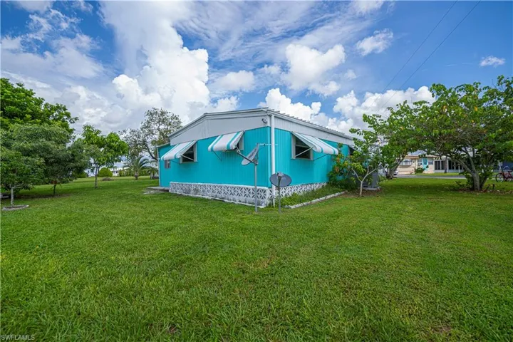 View of side of home featuring a lawn