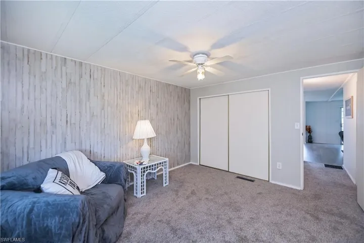 Sitting room with carpet flooring and a ceiling fan