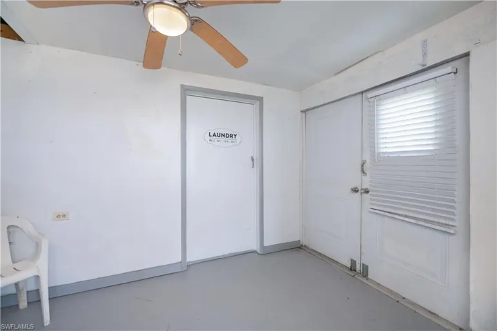 Entryway featuring finished concrete flooring and ceiling fan