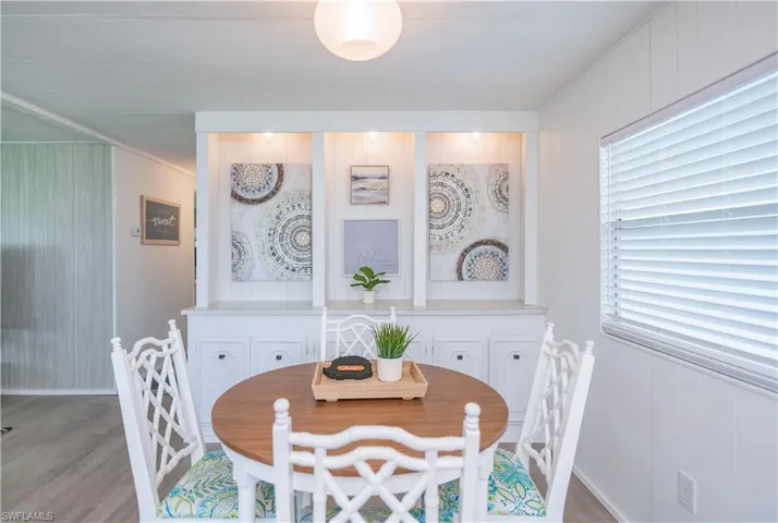 Dining room featuring wood walls and light wood-style floors