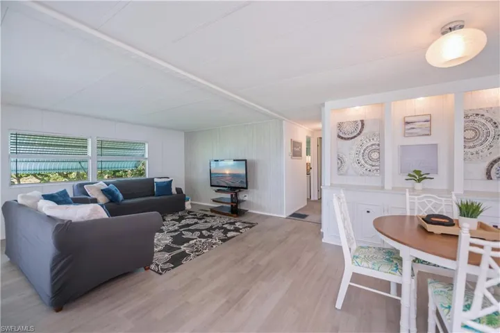 Living room featuring light wood-style floors and wood walls