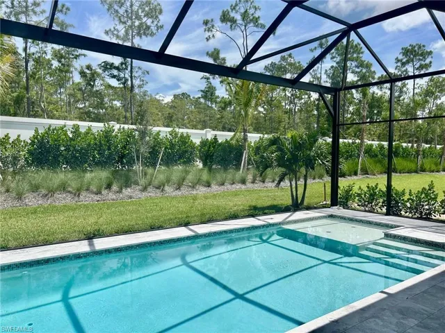 View of pool with a yard and a lanai