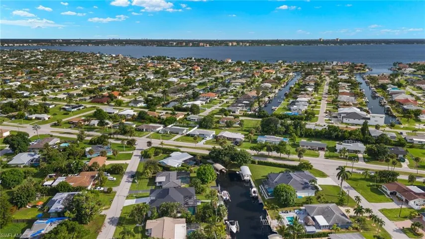Birds eye view of property with a water view