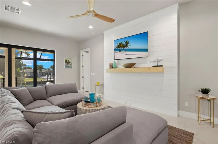 Tiled living room featuring ceiling fan