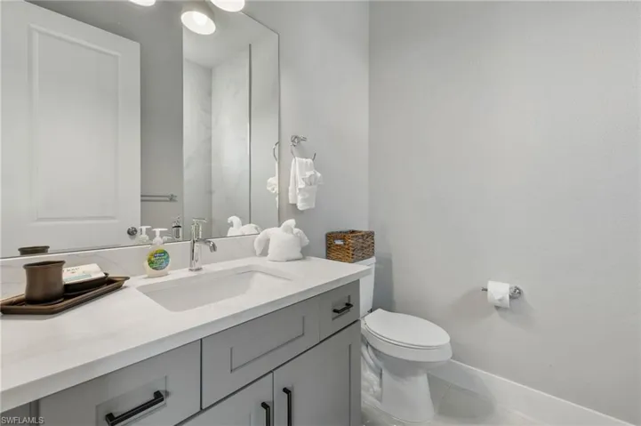 Bathroom with tile patterned floors, toilet, and vanity