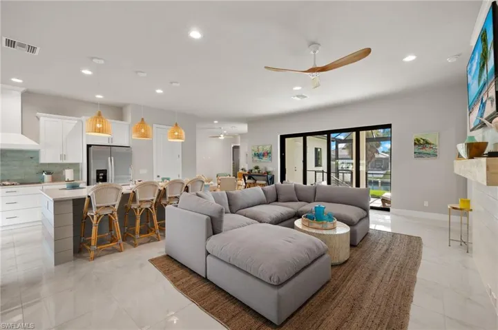 Living room with ceiling fan and a fireplace