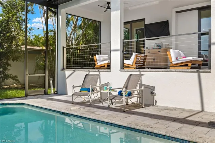 View of pool with a patio and ceiling fan