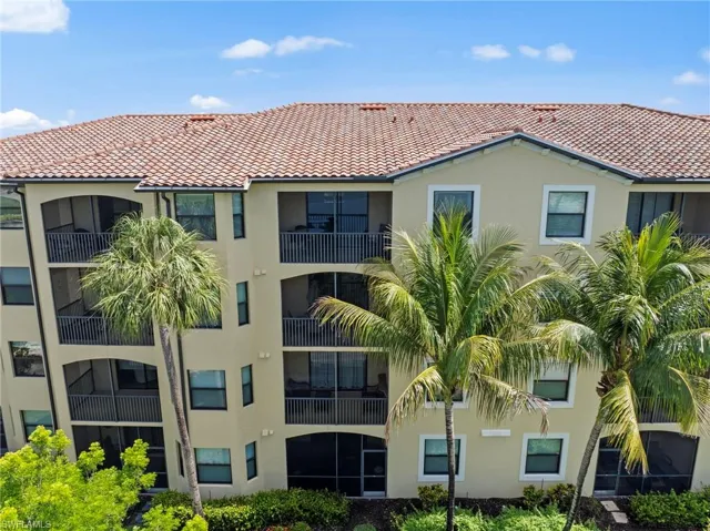 Multi-story residential building featuring a tile roof and stucco exterior