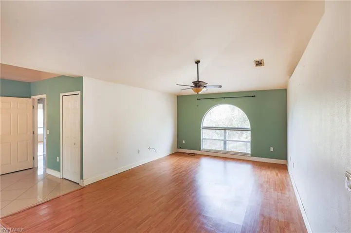 Unfurnished room featuring a ceiling fan and light wood-style floors