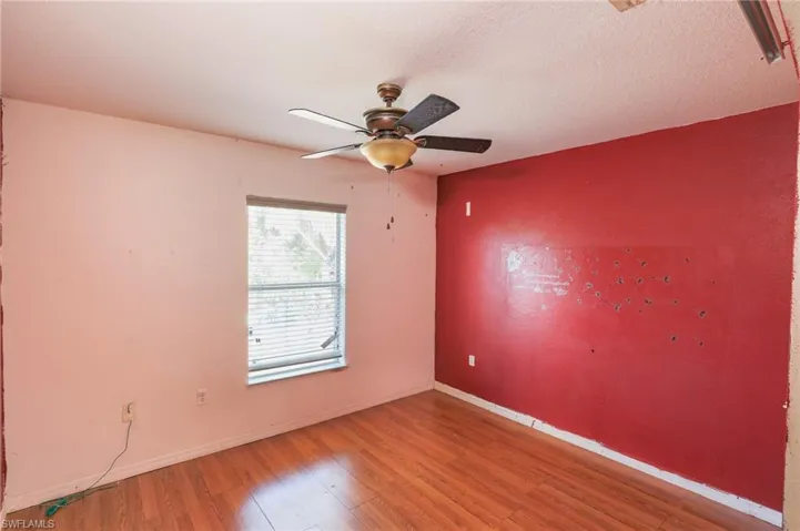 Spare room featuring light wood-type flooring and ceiling fan