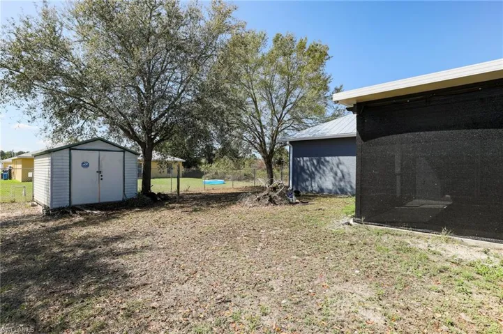 View of yard with a storage unit
