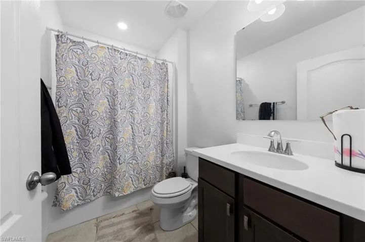 Bathroom with vanity, toilet, and tile patterned floors