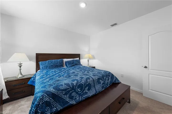 Bedroom featuring carpet floors and baseboards