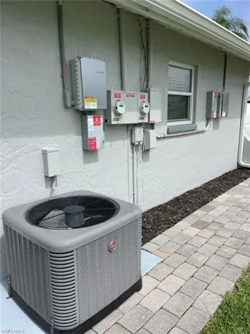 Additional exterior mechanicals showing updated HVAC and dual electrical panels with separate metering for each unit
