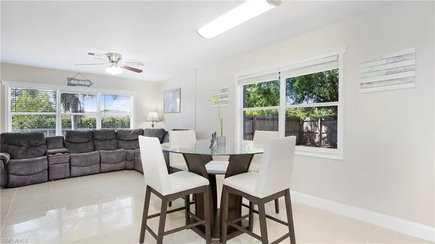 Dining area featuring baseboards, ceiling fan, visible vents, and light tile patterned floors