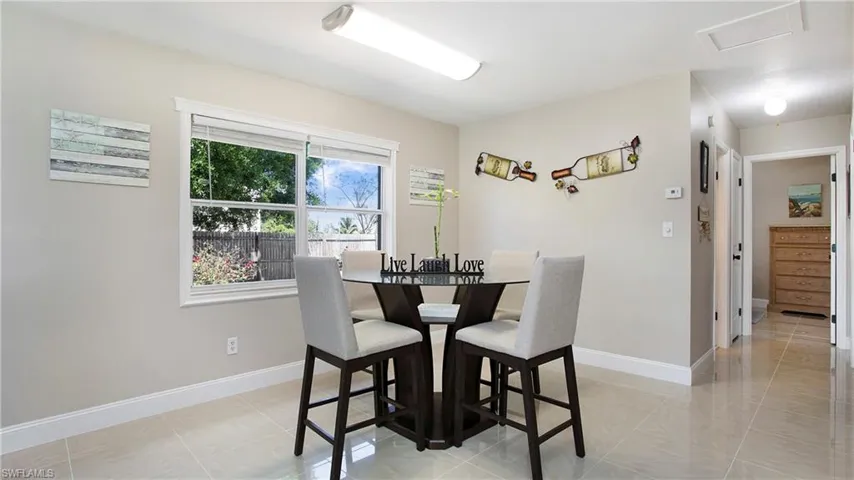 Dining area with baseboards and attic access