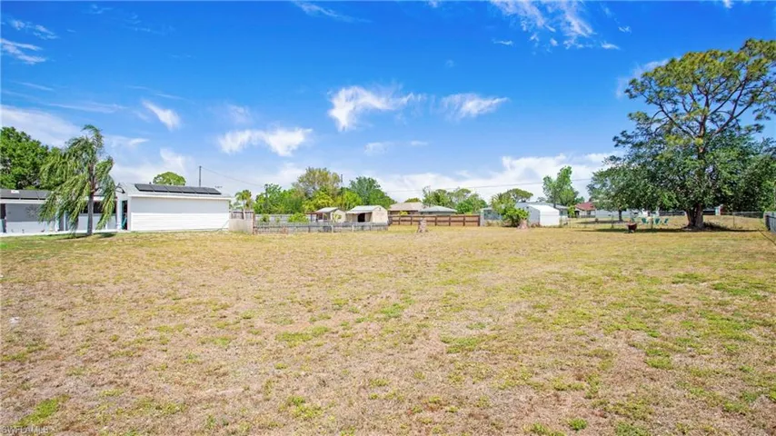 View of yard with an outbuilding and fence