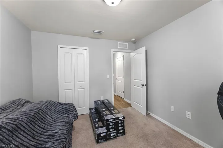 Bedroom with carpet and a closet