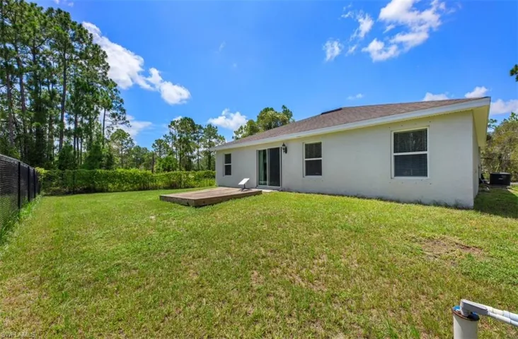 Rear view of house with a yard