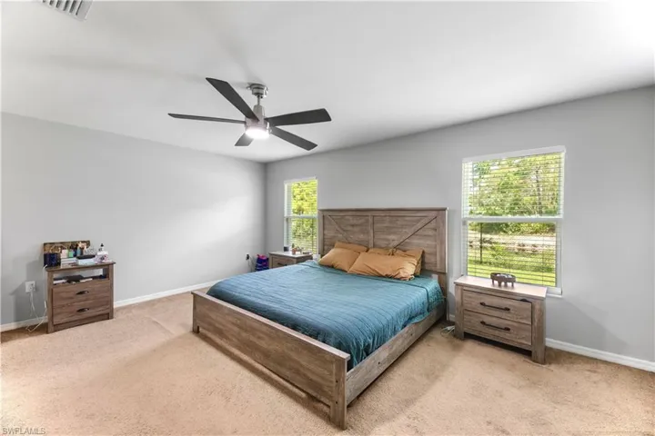 Carpeted bedroom with ceiling fan