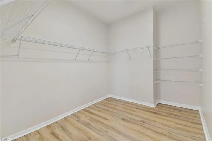 Walk in closet featuring light hardwood / wood-style flooring