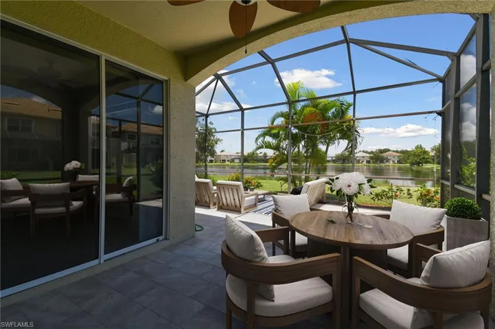 Sunroom with a water view and ceiling fan