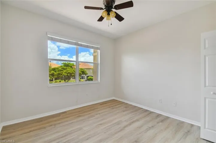 Unfurnished room featuring ceiling fan and light wood-type flooring