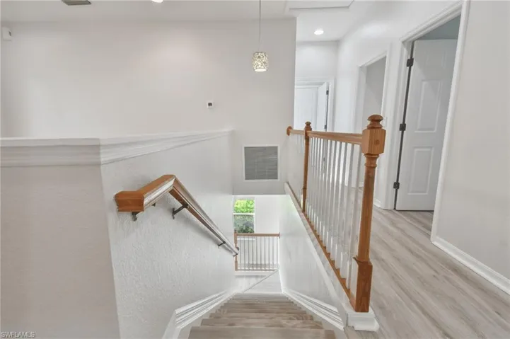 Staircase featuring light hardwood / wood-style flooring