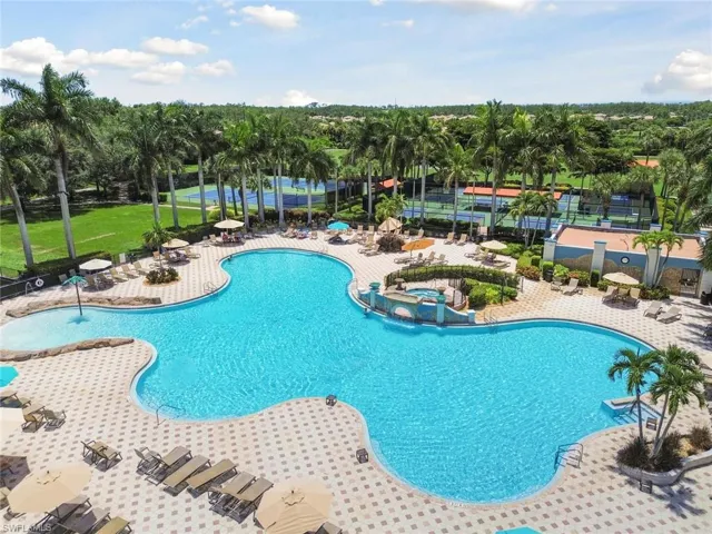 View of pool with a patio and a hot tub