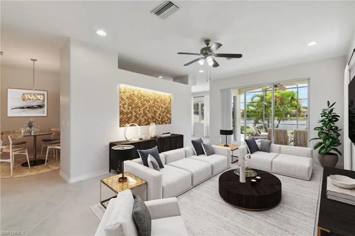 Living room with light tile patterned flooring and ceiling fan