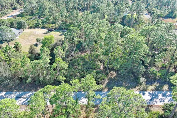 View of property location featuring a heavily wooded area