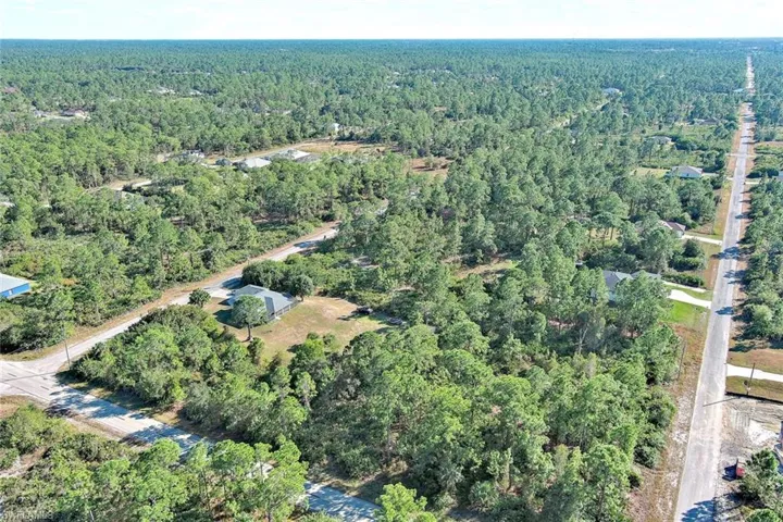 Aerial overview of property's location featuring a heavily wooded area