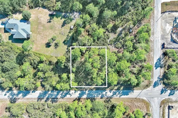 Aerial view of property and surrounding area with property parcel outlined
