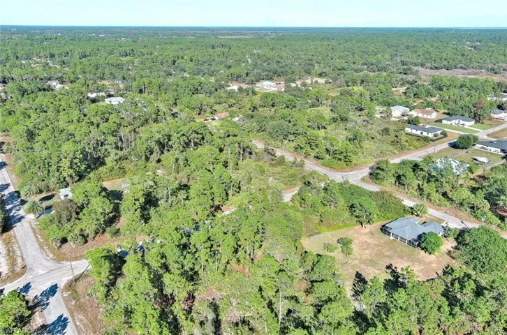 View of property location featuring a heavily wooded area