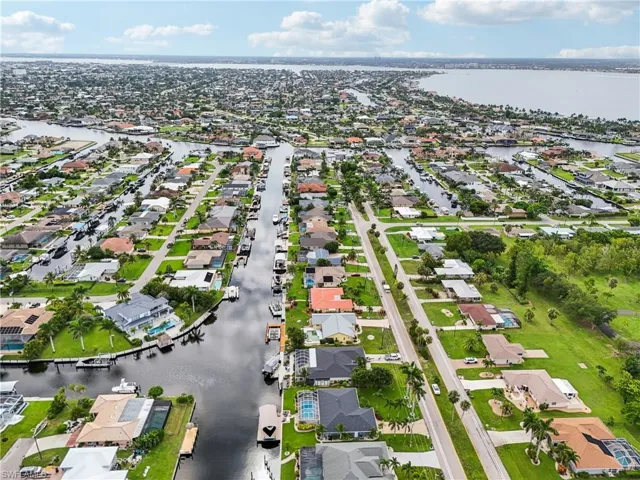 Aerial overview of property's location featuring nearby suburban area and a large body of water