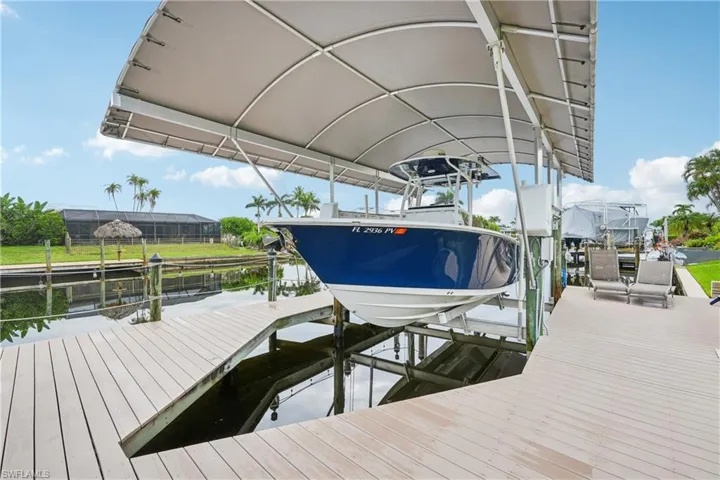 Dock area with boat lift and a water view