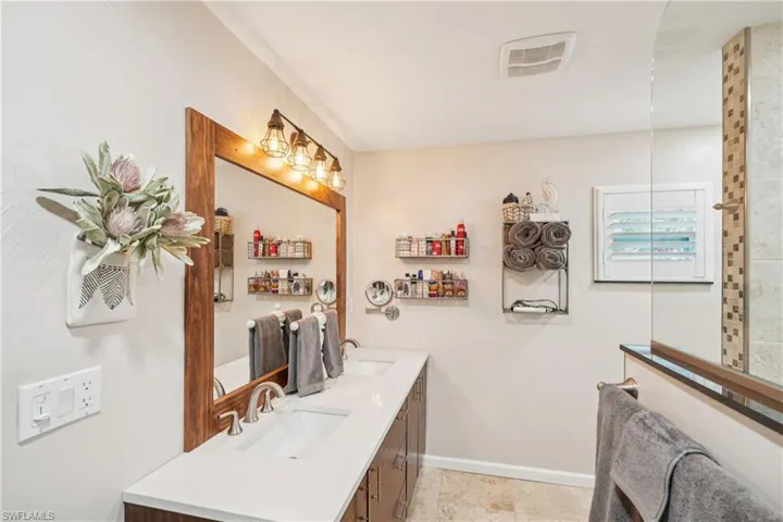 Full bath with double vanity and tile patterned flooring