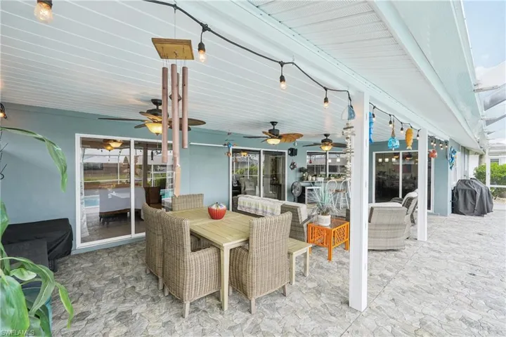 View of patio featuring a ceiling fan, a grill, and outdoor dining area