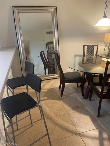 Dining area featuring light tile patterned flooring and baseboards