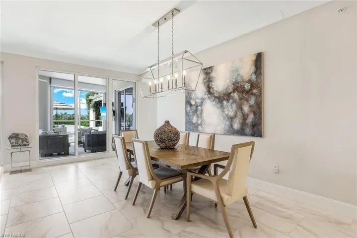 Dining area framed by custom lighting andoutdoor views.