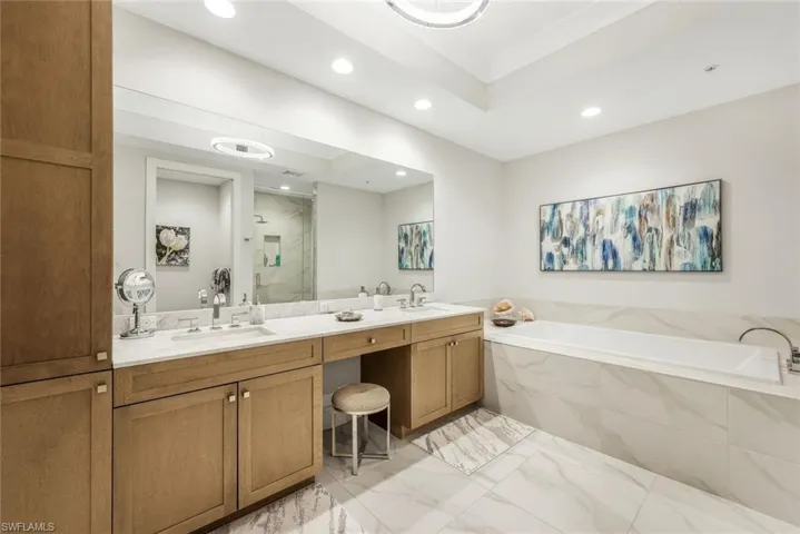 Primary bath offers spa-inspired relaxation with dual vanities and soaking tub.