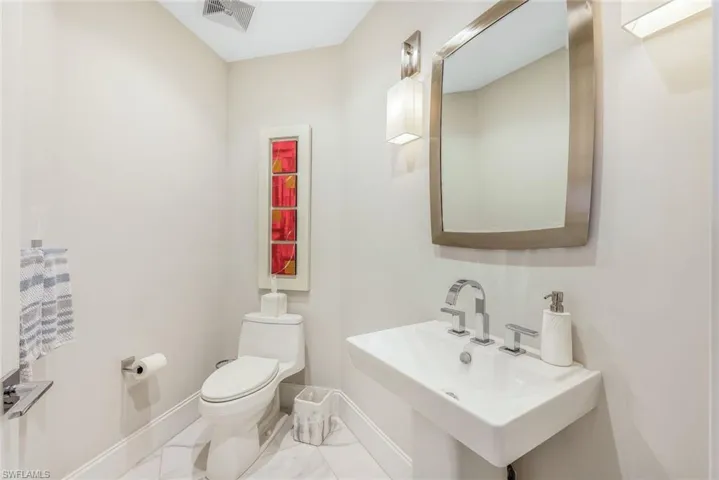 Charming powder room located across from the den/office.