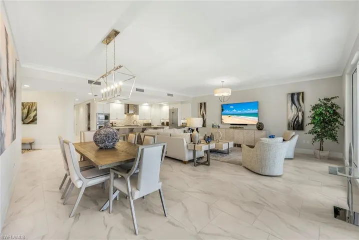 The large great room offers floor to ceiling windows with so much gathering space for friends and family.