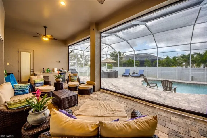 View of patio featuring an outdoor living space, ceiling fan, a lanai, and a sunroom