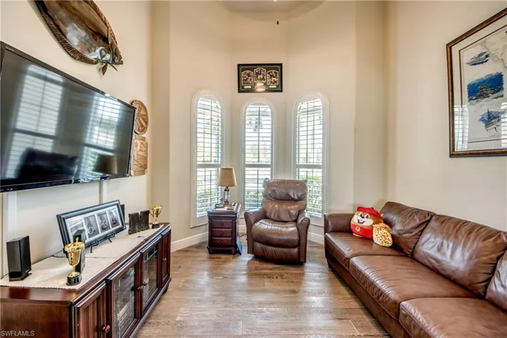 Living room with light wood finished floors and a high ceiling